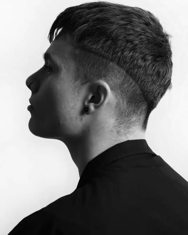 Side profile of a short textured cut with a clean taper